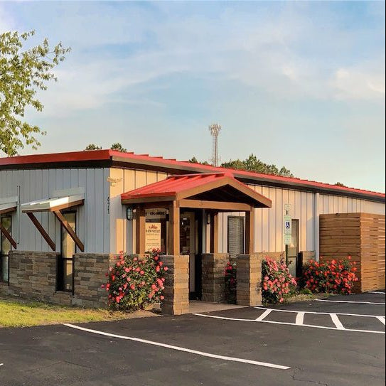 Small building with a red roof and a parking lot in front