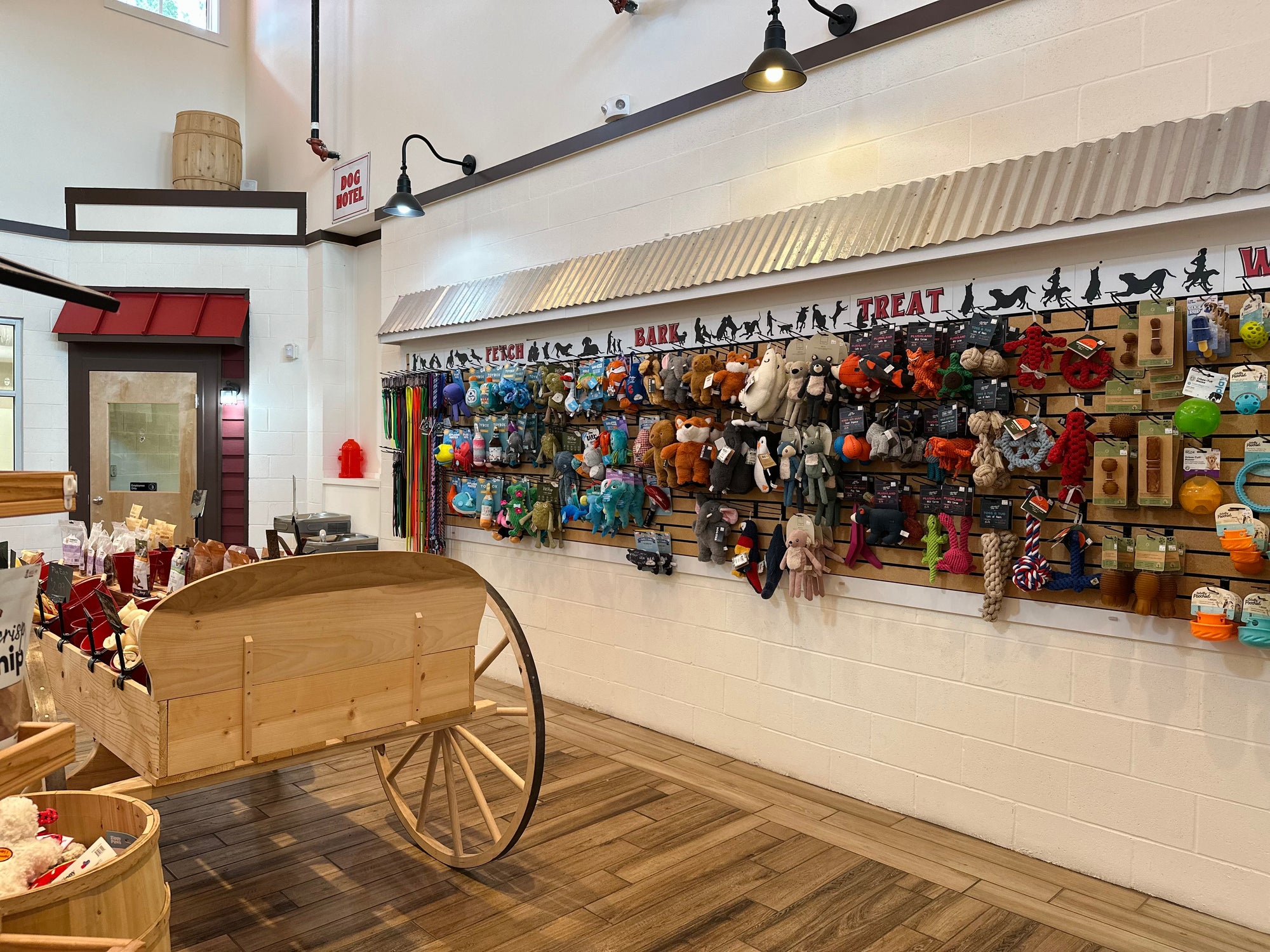 Store interior with wooden cart and product display wall.