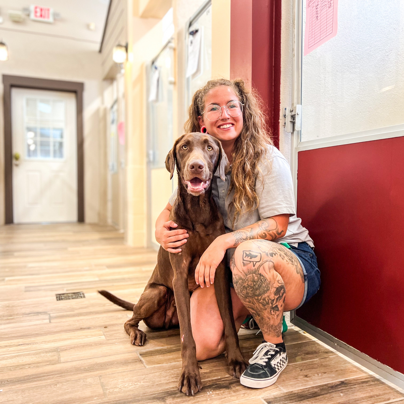 Employee with dog smiling 